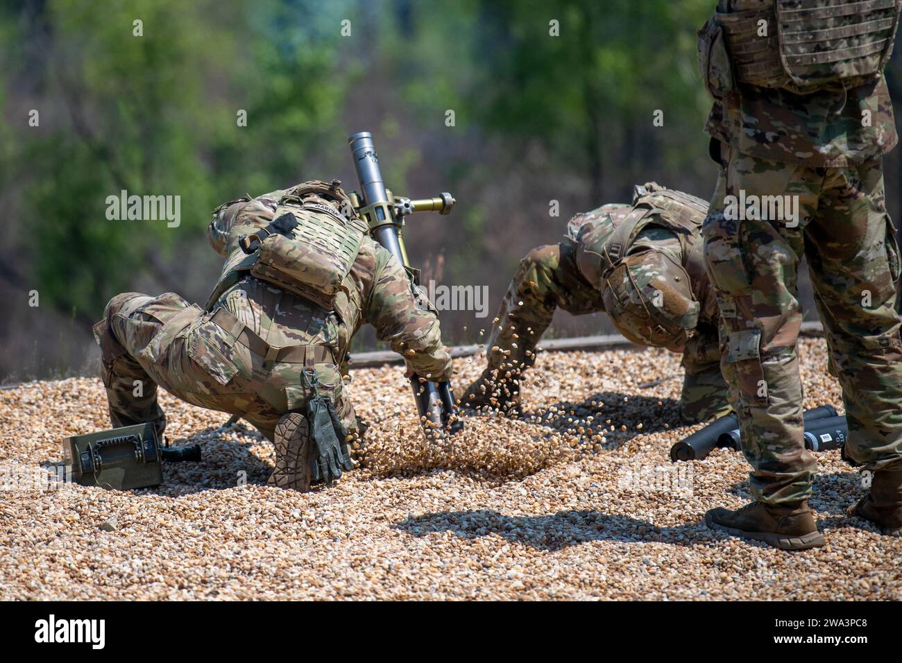 Soldiers aim and shoot a handheld and bipodstabilized 60mm mortar