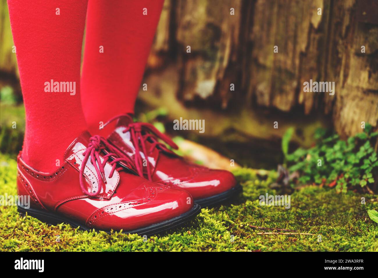 Fashion modern red shoes on kid's feet Stock Photo