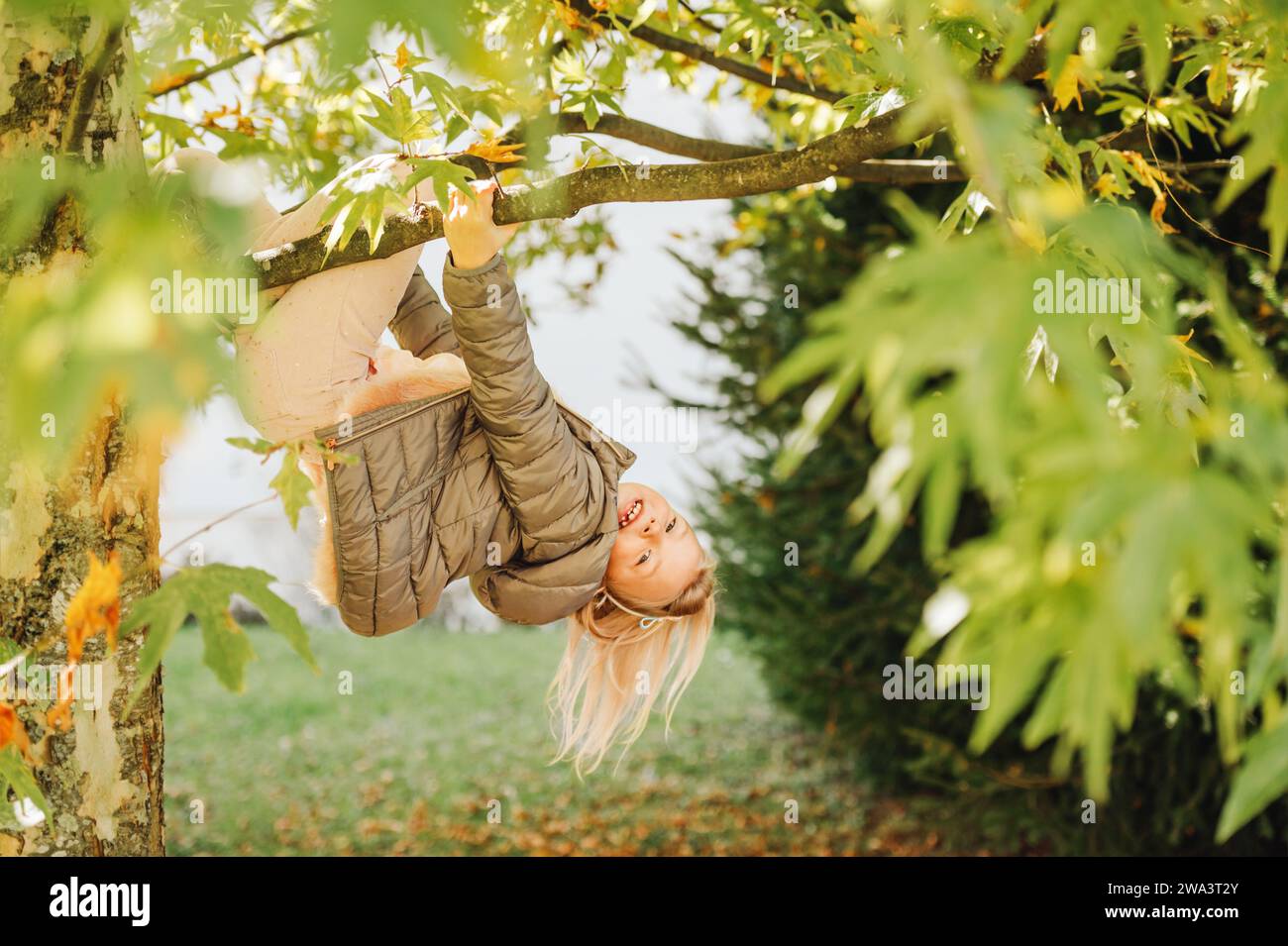 Outdoor portrait of cute little kid girl playing in the park, child ...