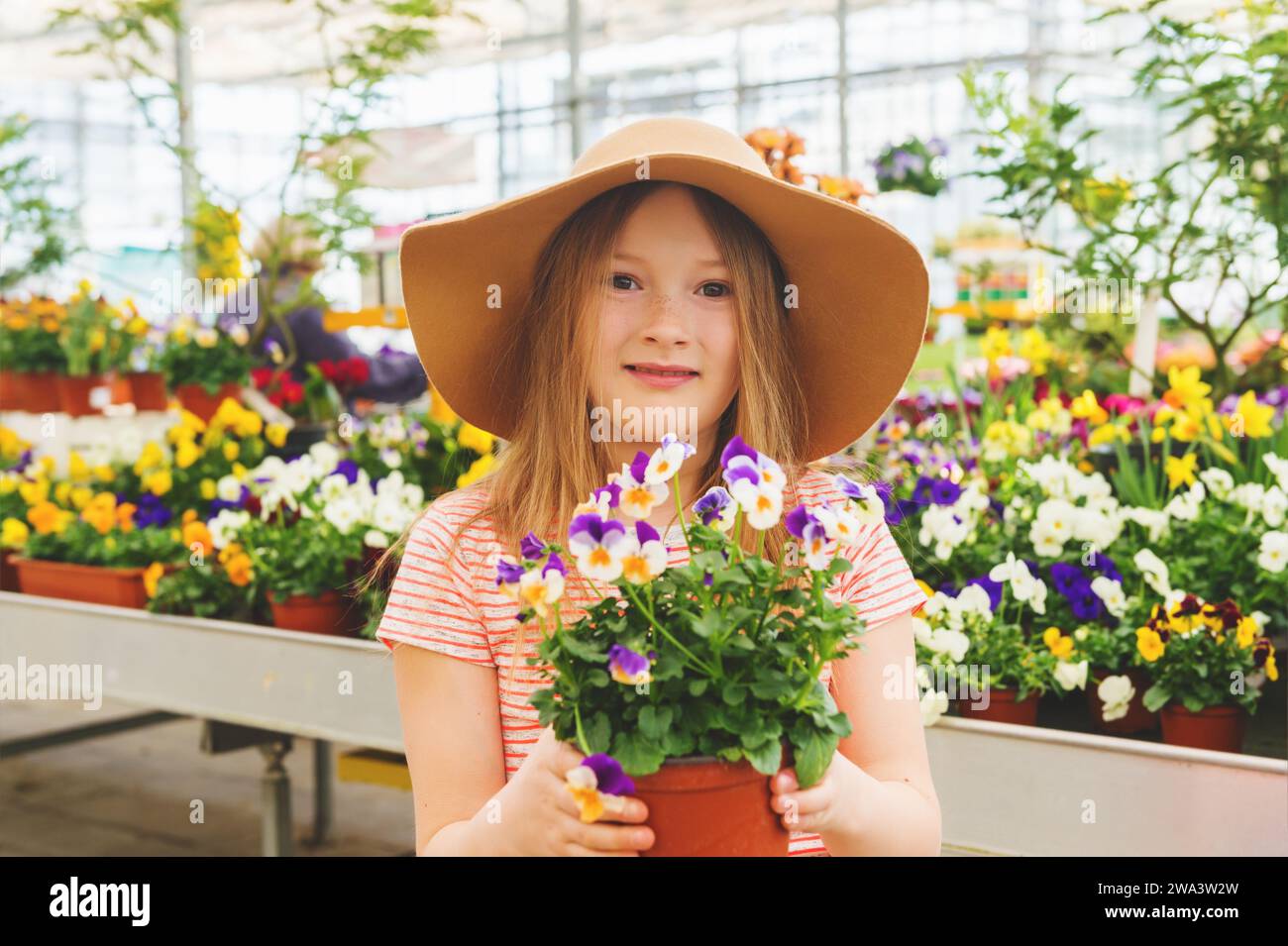 Adorable little girl choosing flowers in garden center Stock Photo Alamy
