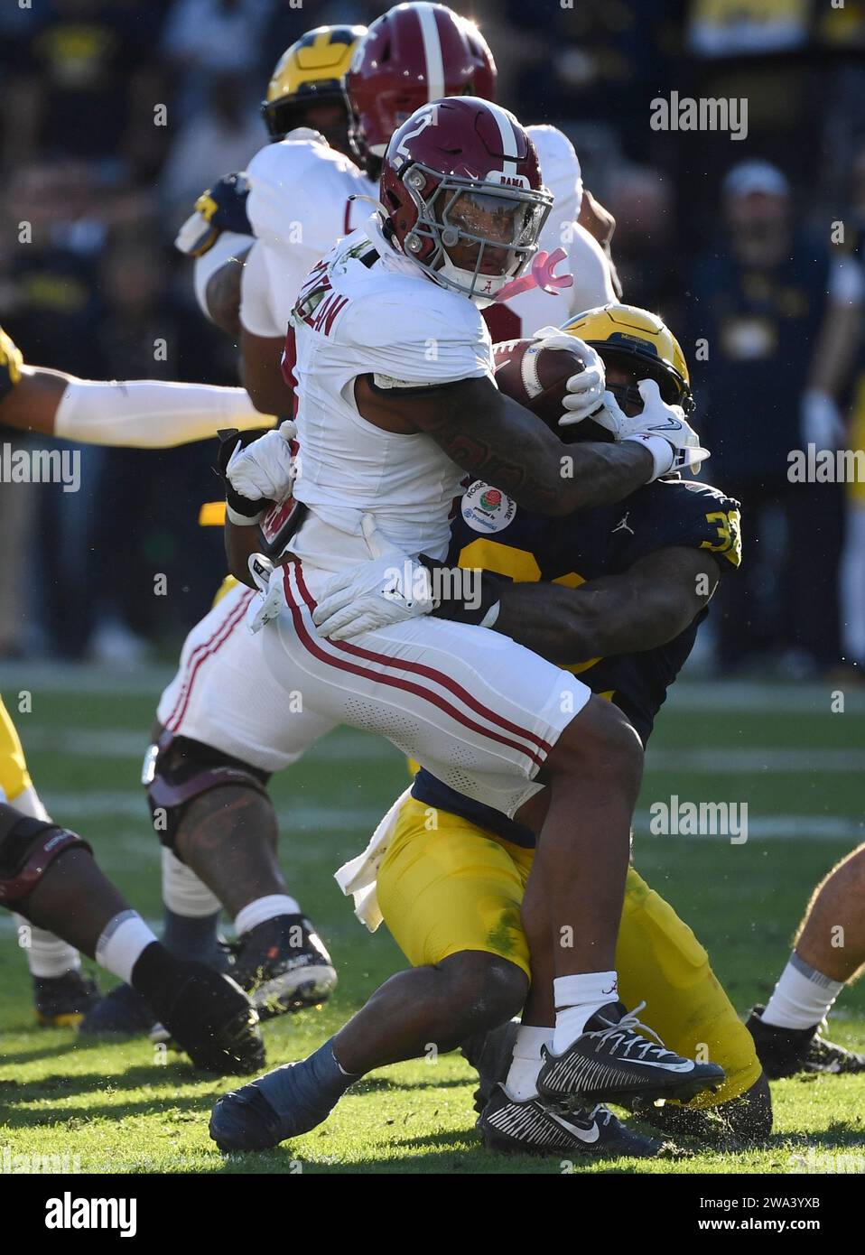 Pasadena, United States. 01st Jan, 2024. Alabama Crimson Tide running back Jase McClellan is tackled by Michigan Wolverines defensive end Jaylen Harrell in the second quarter in the 2024 Rose Bowl NCAA football game at the Rose Bowl in Pasadena, California on Monday, January 1, 2024. Photo by Jon SooHoo/UPI Credit: UPI/Alamy Live News Stock Photo