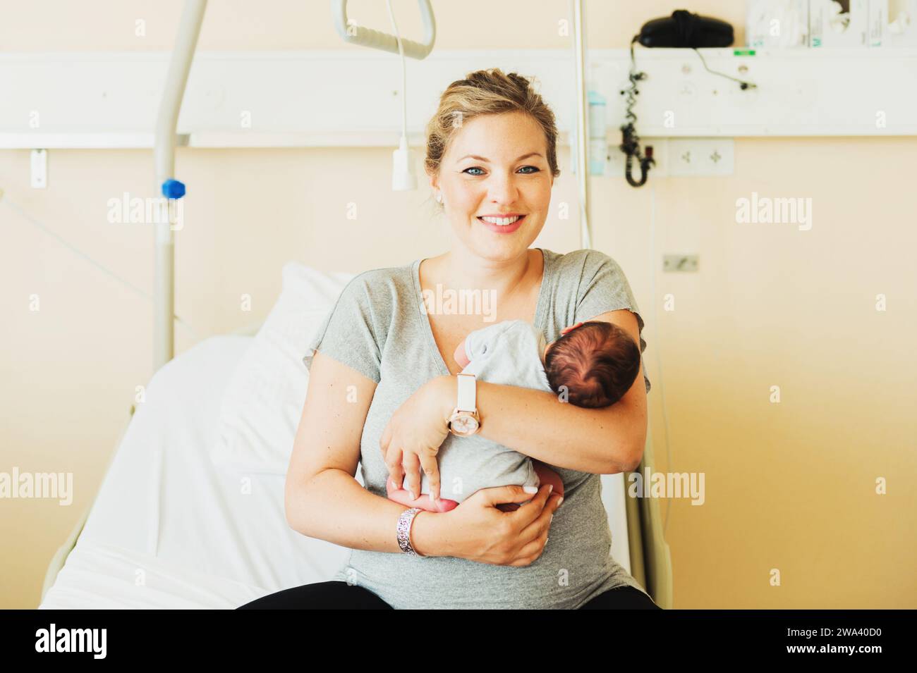 Happy young mother with newborn baby in hospital after giving birth Stock Photo
