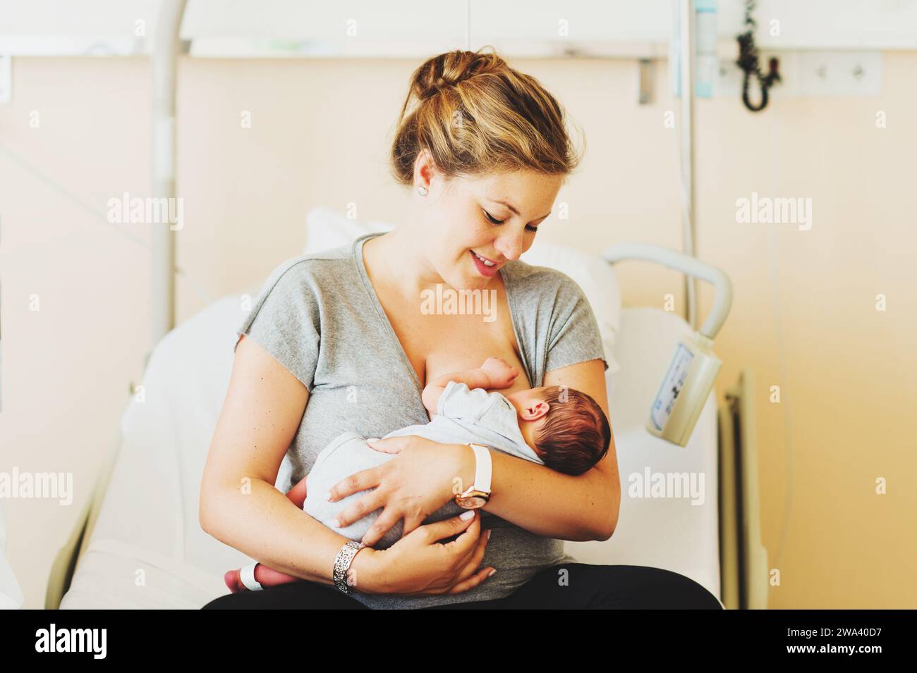 Happy young mother with newborn baby in hospital after giving birth Stock Photo