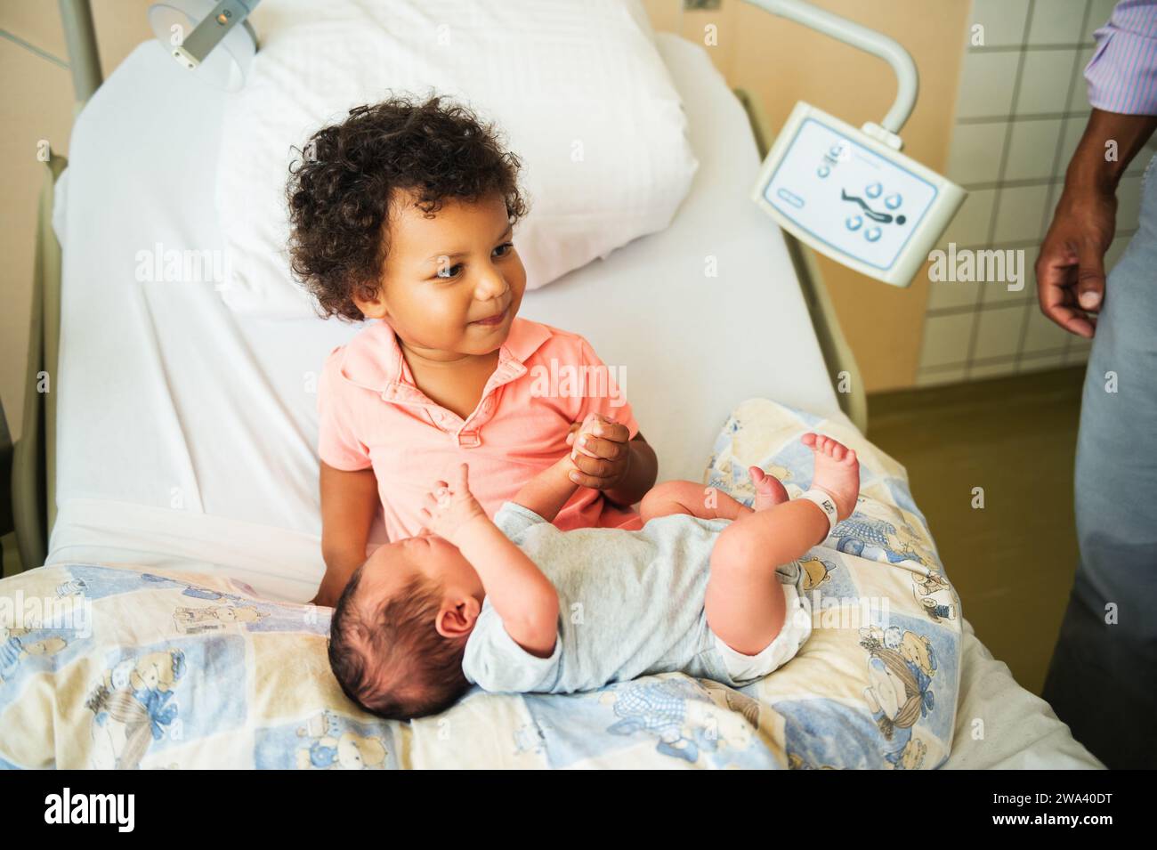 First meeting of adorable african toddler boy and his newborn brother in a prenatal hospital Stock Photo