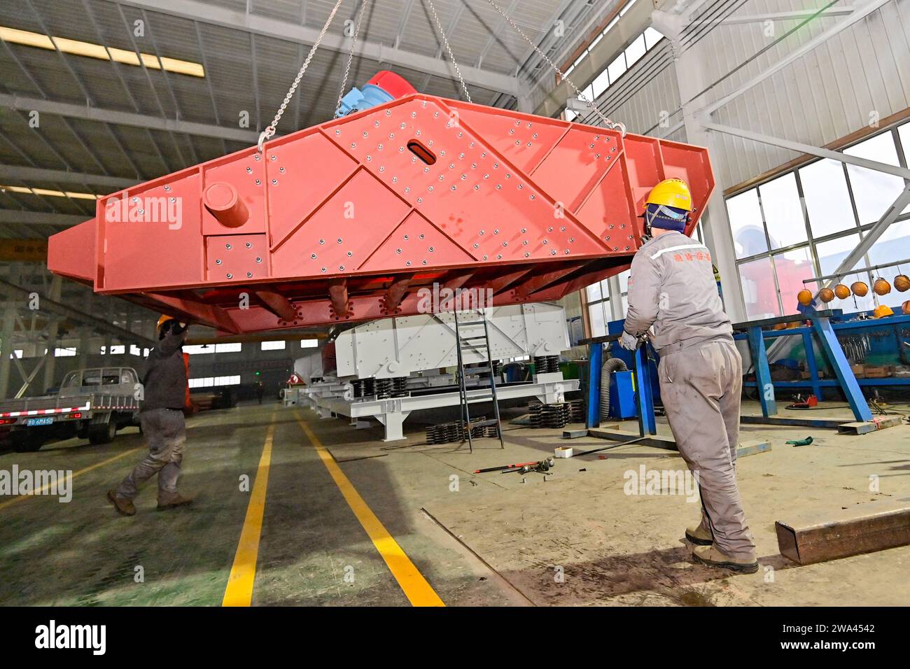 QINGZHOU, CHINA - JANUARY 2, 2024 - A worker lifts equipment at a ...