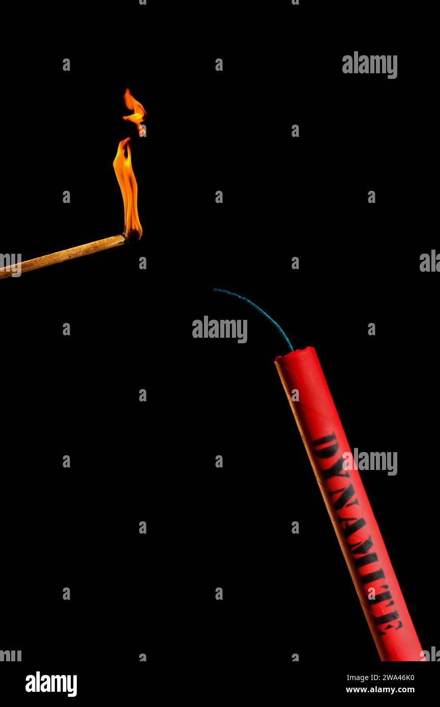 A matching lighting fuse of a red stick of dynamite against a black background Stock Photo Alamy