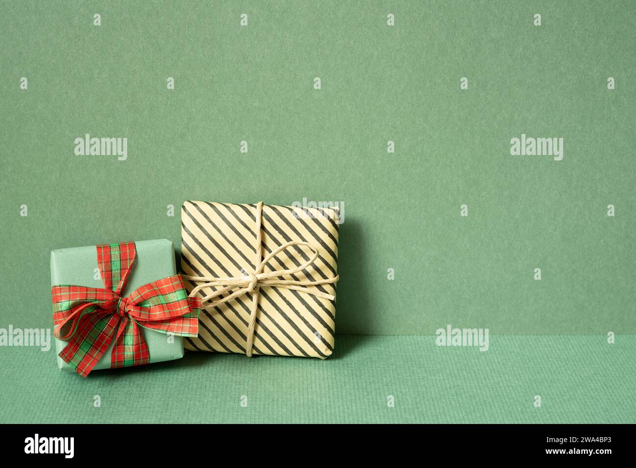 Gift boxes on table. green wall background. copy space Stock Photo