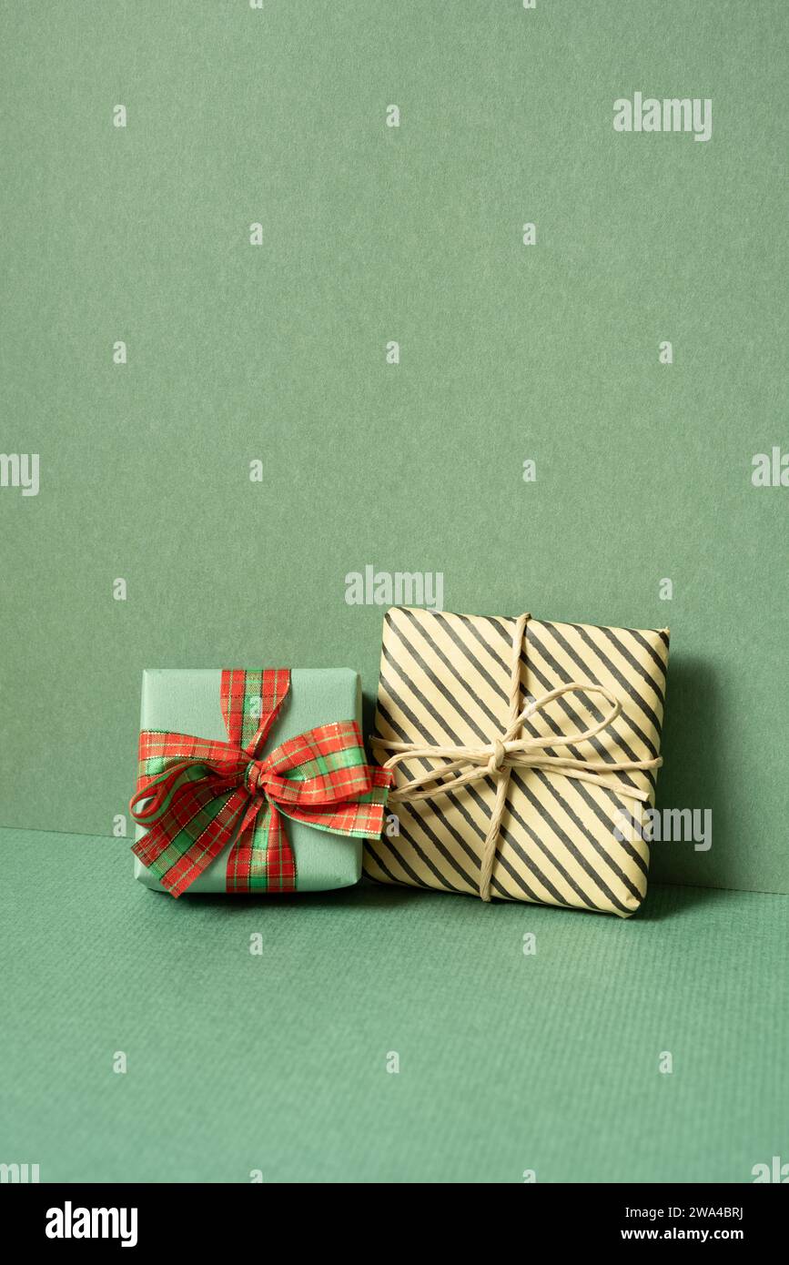 Gift boxes on table. green wall background. copy space Stock Photo