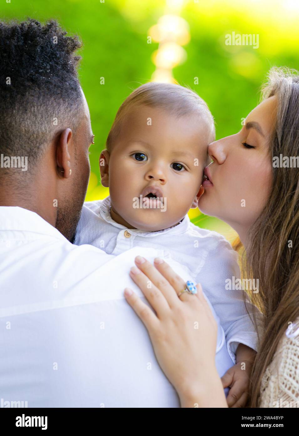 Mothers kissed baby. Close up portrait of mother kissing multiracial baby. Mother kiss child