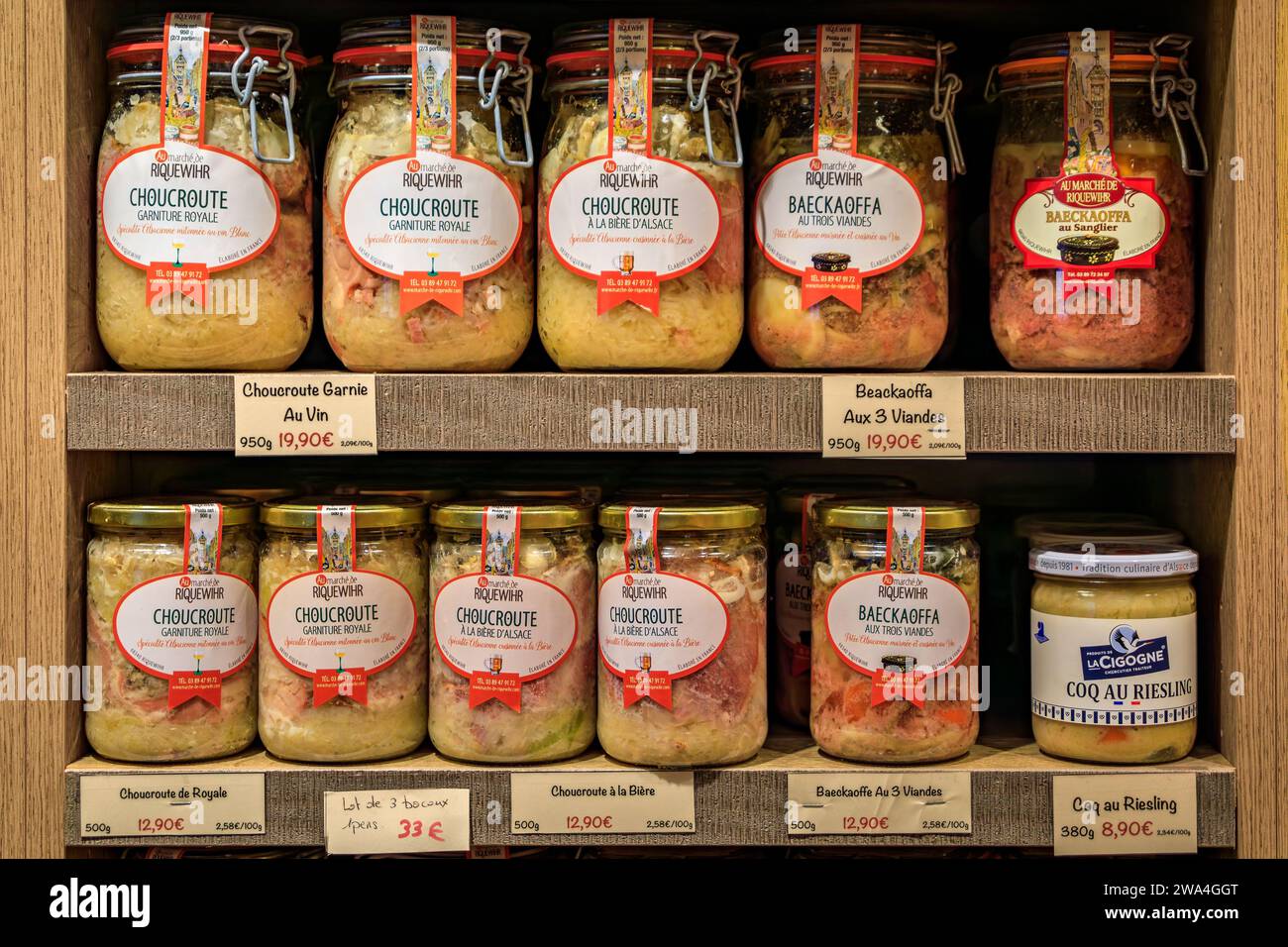Riquewihr, France - June 2, 2023: Traditional Alsatian baeckeoffe or baker's oven stew and choucroute sauerkraut in jars, display at a souvenir store Stock Photo