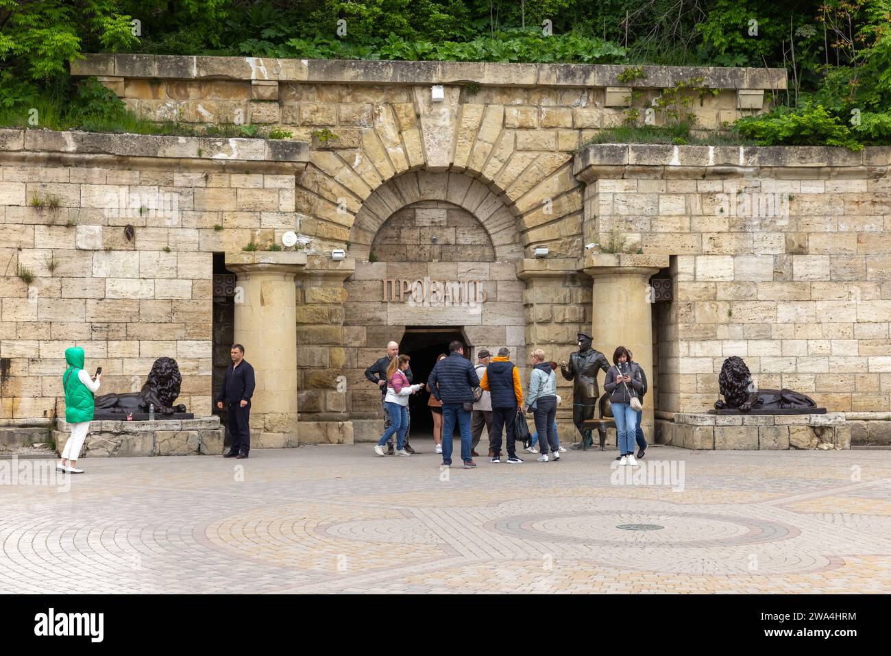 Pyatigorsk, Russia - May 12, 2023: Tourists at the entrance of Proval, it is a natural well of karst-tectonic origin on the southern slope of Mount Ma Stock Photo