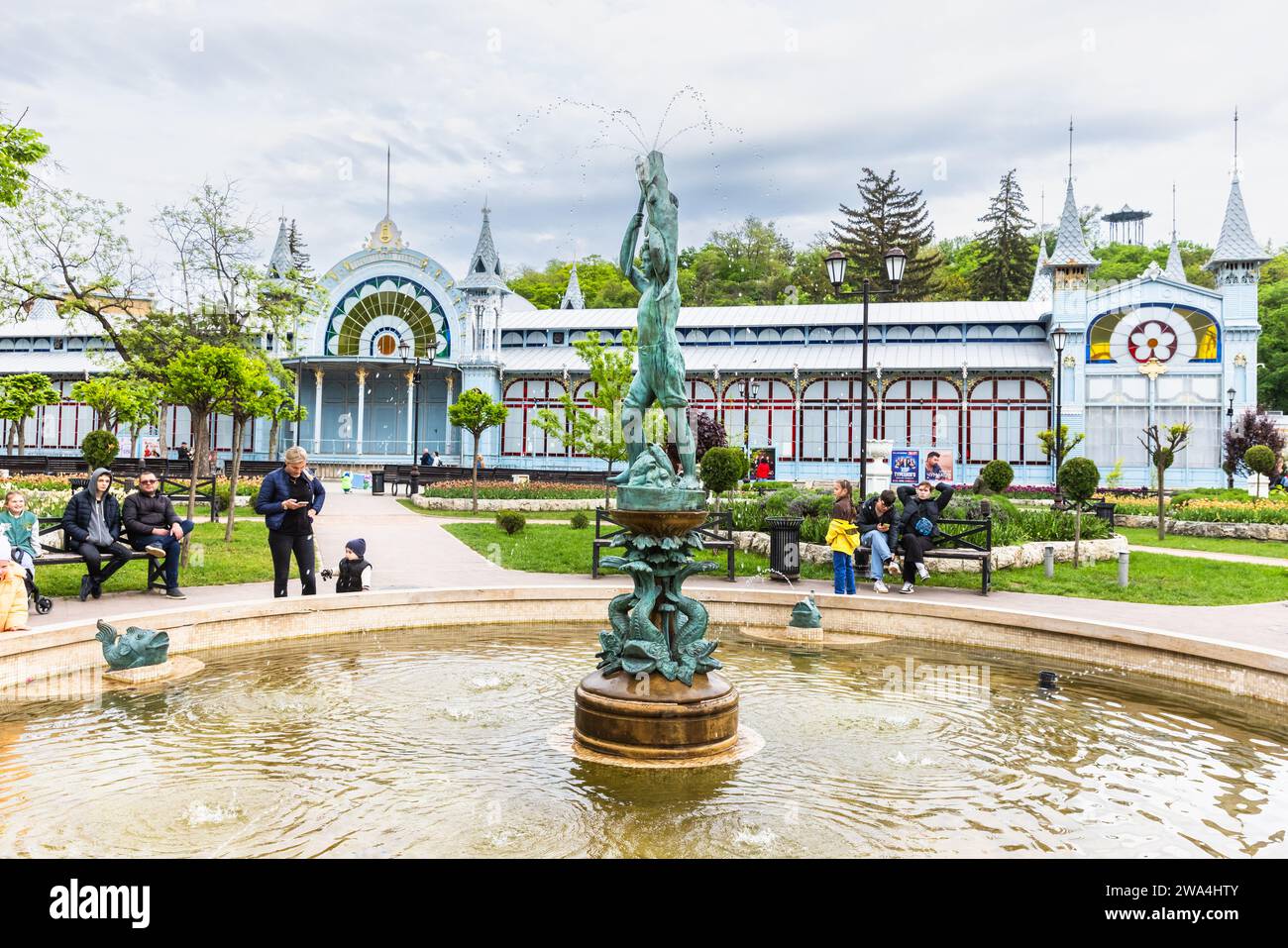 Pyatigorsk, Russia - May 12, 2023: Tourists visit Pyatigorsk Park Tzvetnik or Flower Garden with Lermontov Gallery on the background Stock Photo