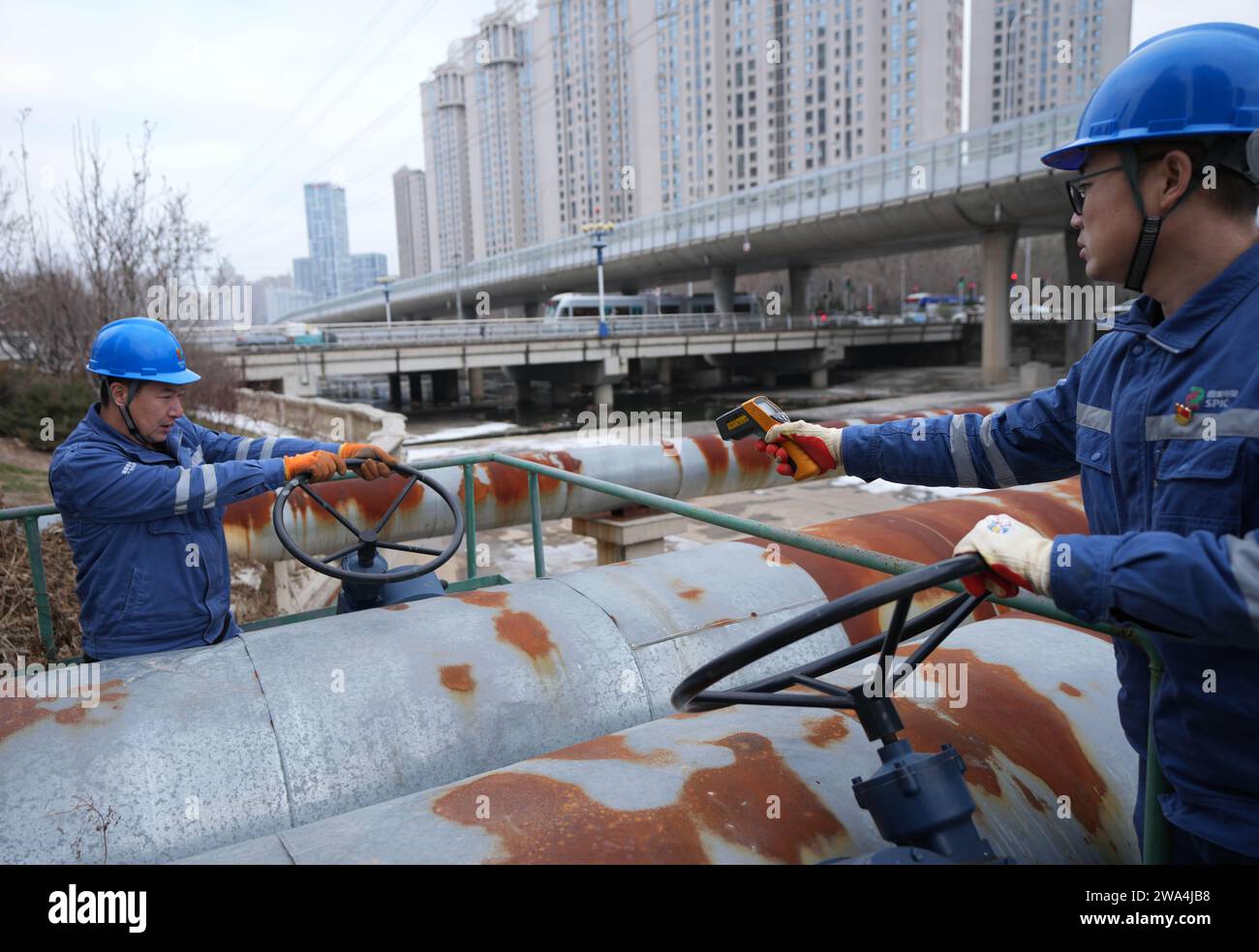 Beijing, China's Liaoning Province. 1st Jan, 2024. Staff members check heating pipelines in Dalian, northeast China's Liaoning Province, Jan. 1, 2024. Credit: Li Gang/Xinhua/Alamy Live News Stock Photo