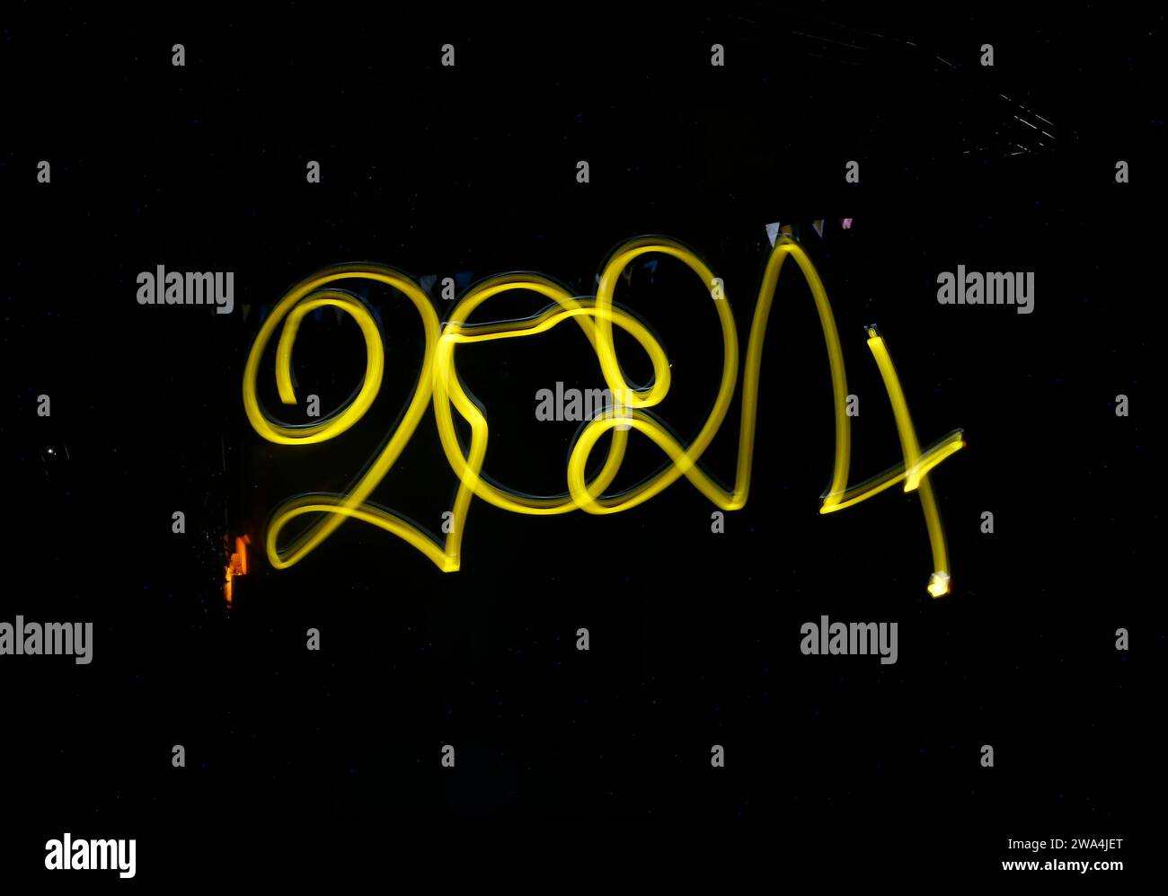 2024 Lettering Yellow yellow 2024 word light painting on black background Stock Photo - Alamy