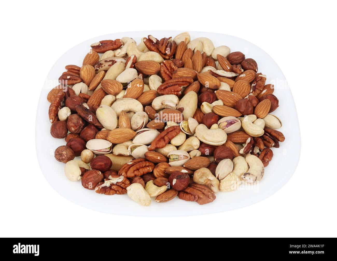 Mix of different nuts on a plate isolated on white Stock Photo