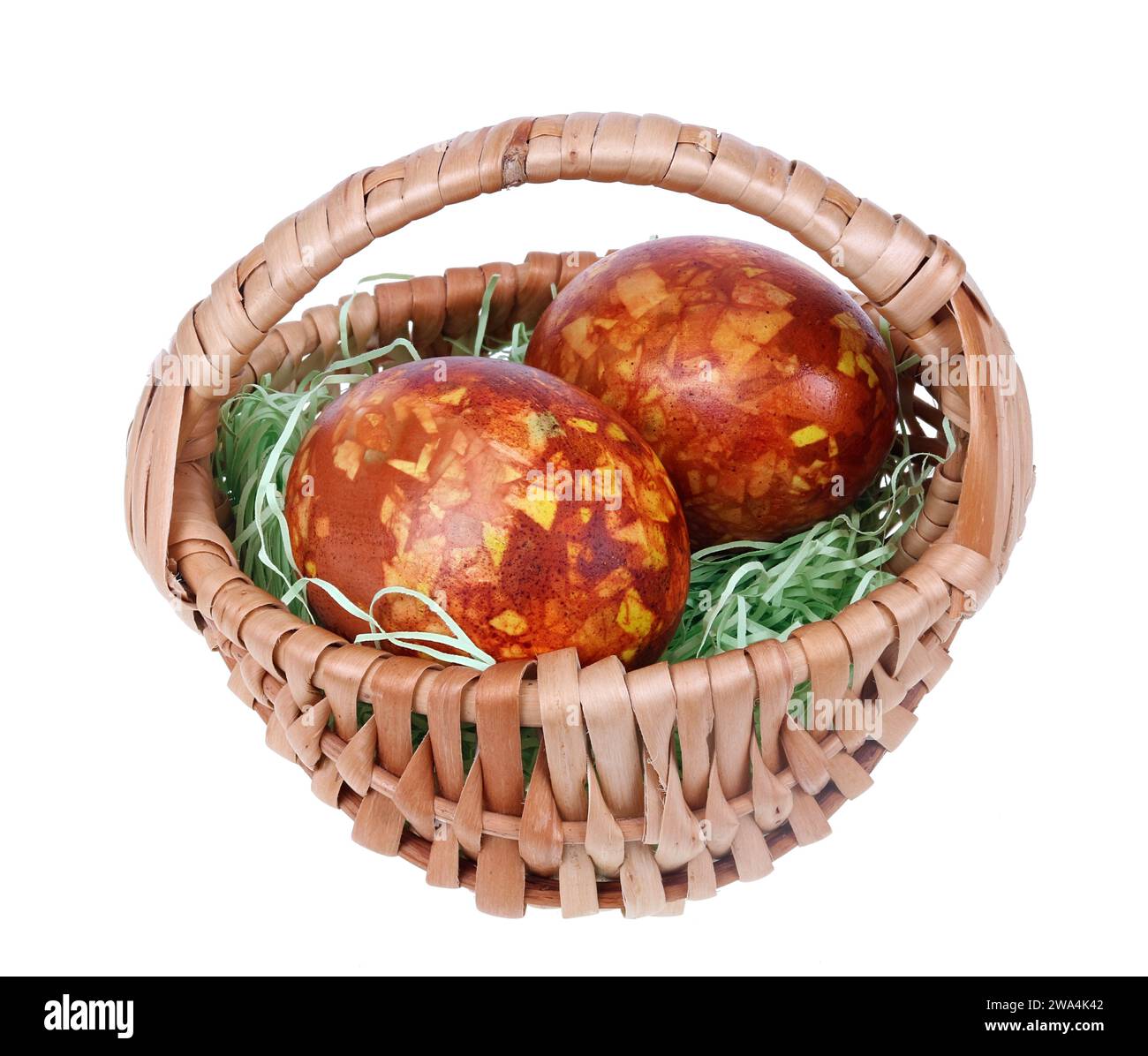 Two Easter eggs in a homemade basket  isolated macro Stock Photo