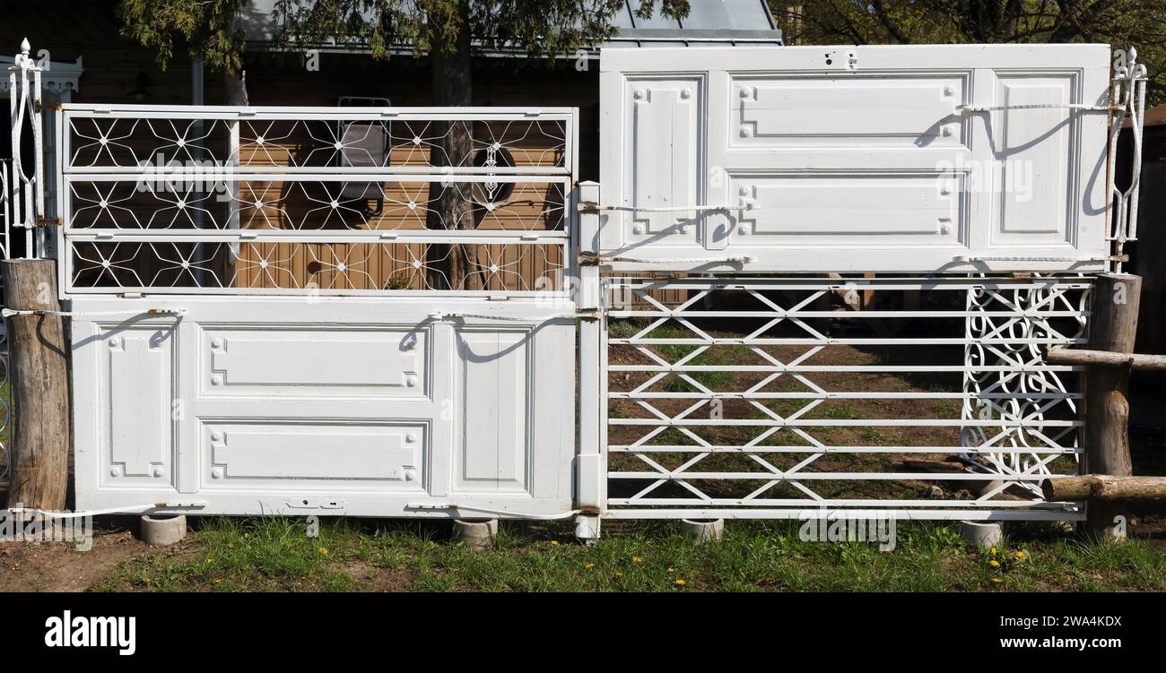 Rustic fence made from old  white doors Stock Photo
