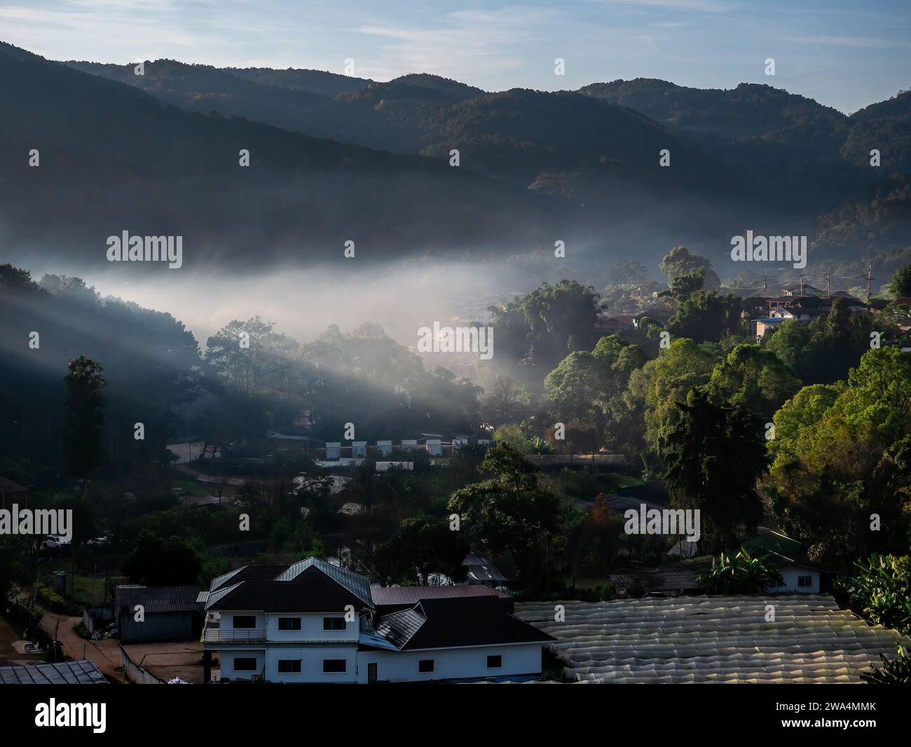 The mist shrouded the village in the valley Stock Photo - Alamy