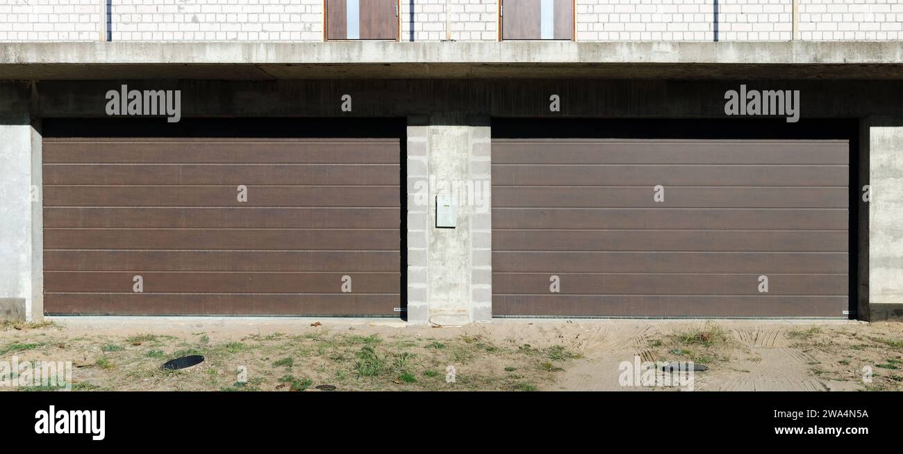 Modern roll up garage doors in the new brick house Stock Photo Alamy