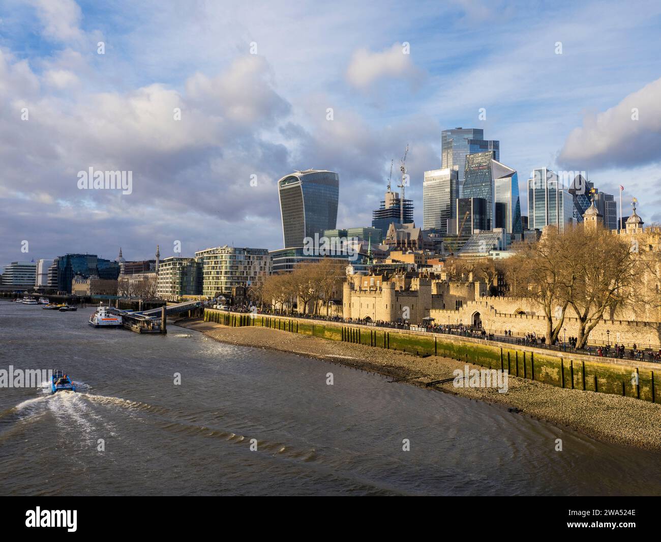 Boat Travelling on the River Thames, with the Tower of London and City of London, London, England, UK, GB. Stock Photo