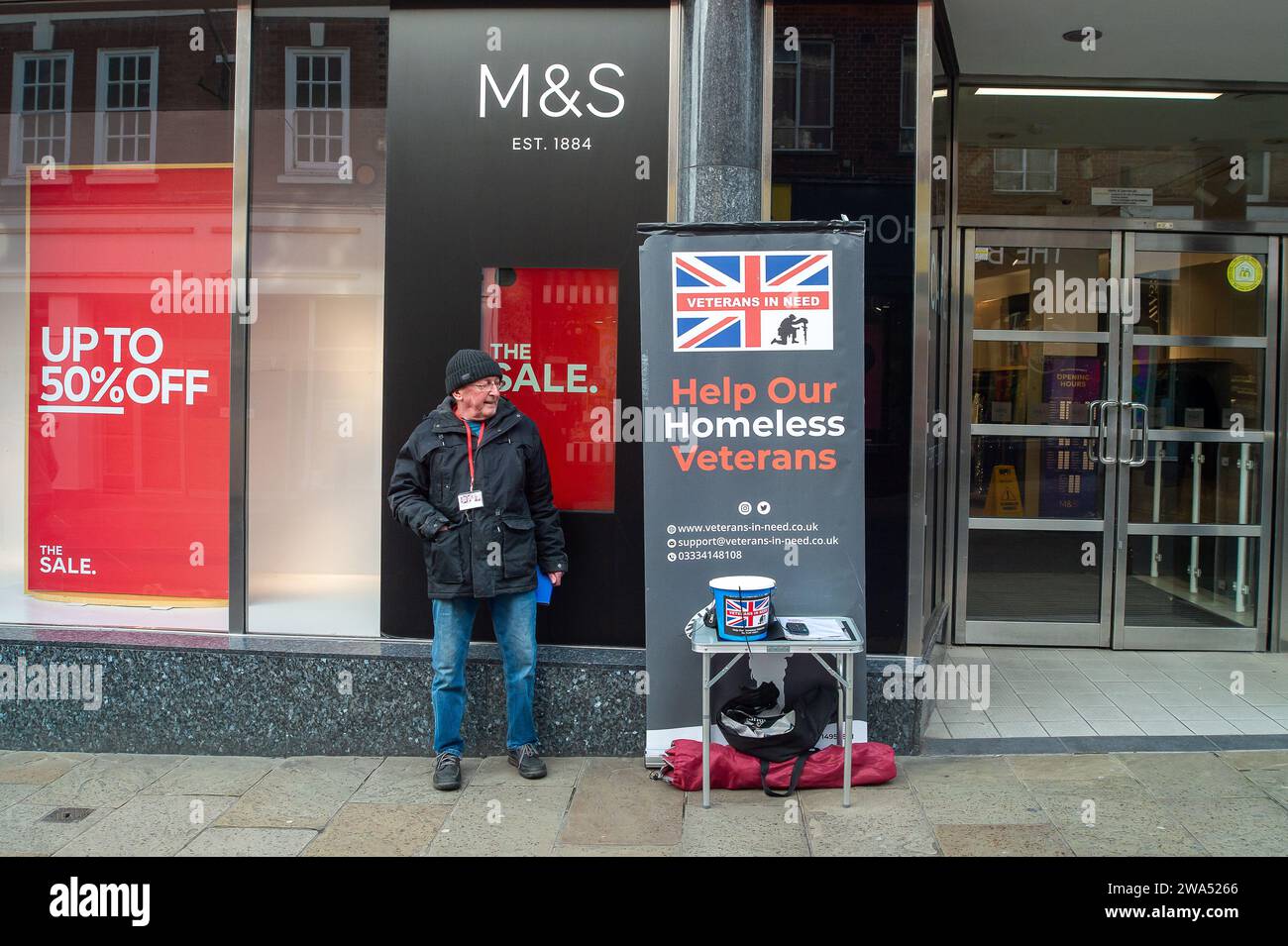 Windsor, UK. 29th December, 2023. A many collects charitable donations in Windsor Berkshire for Homeless Veterans. There continues to be a lot of resentment shown on social media that immigrants are housed in four star hotels whilst some ex veterans in the UK are homeless. Credit: Maureen McLean/Alamy Stock Photo