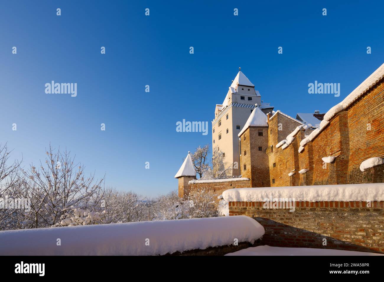 The outside of Castle Trausnitz in Landshut, Lower Bavaria with snow covered walls and roofs in winter on sunny day Stock Photo