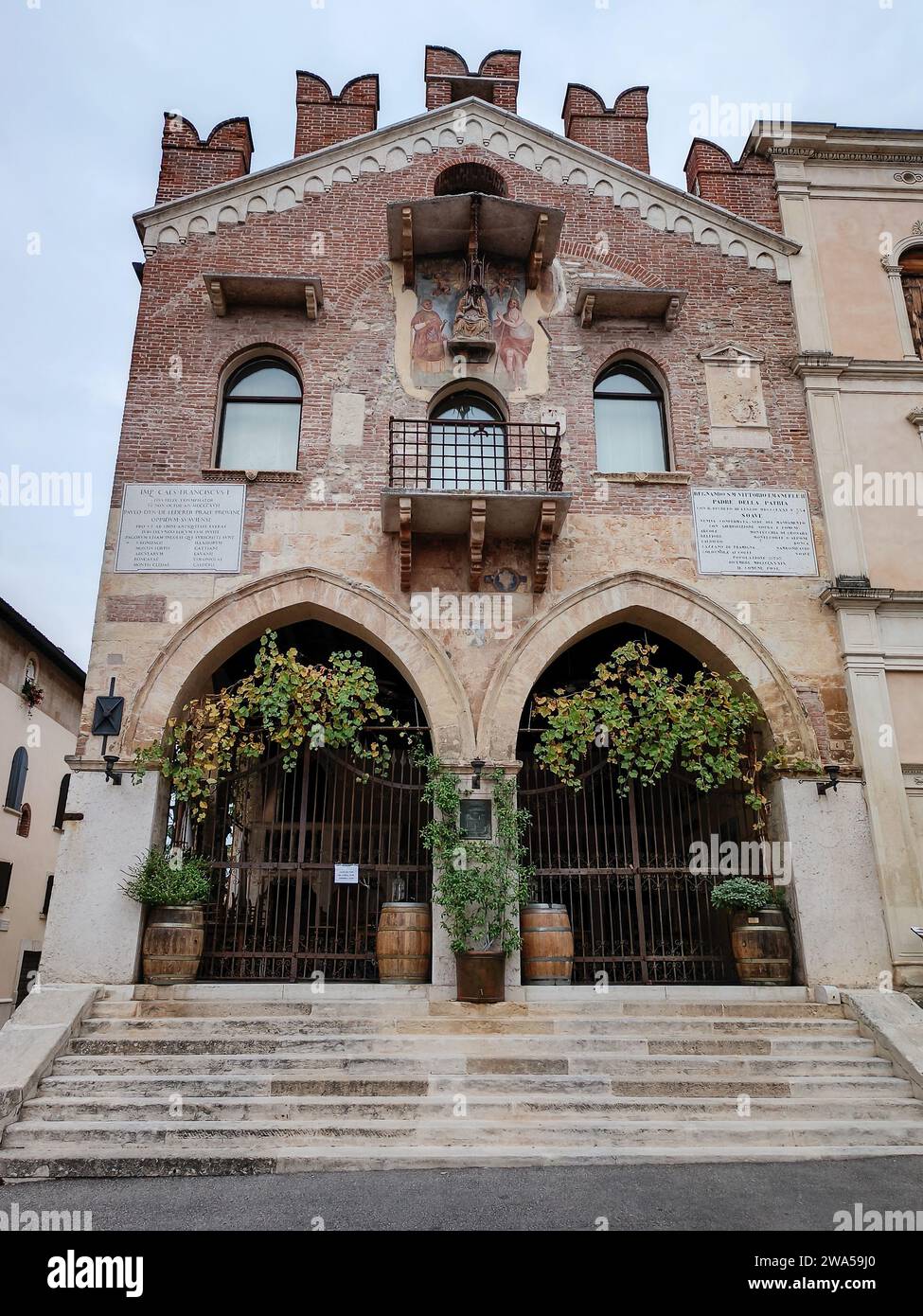 the facade of a historic building in the center of Soave Stock Photo