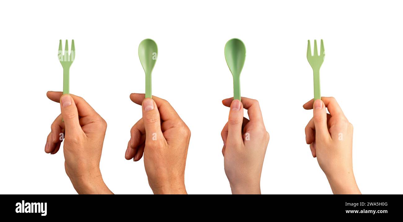 Hands holding eco reusable plastic spoon and fork set isolated on white