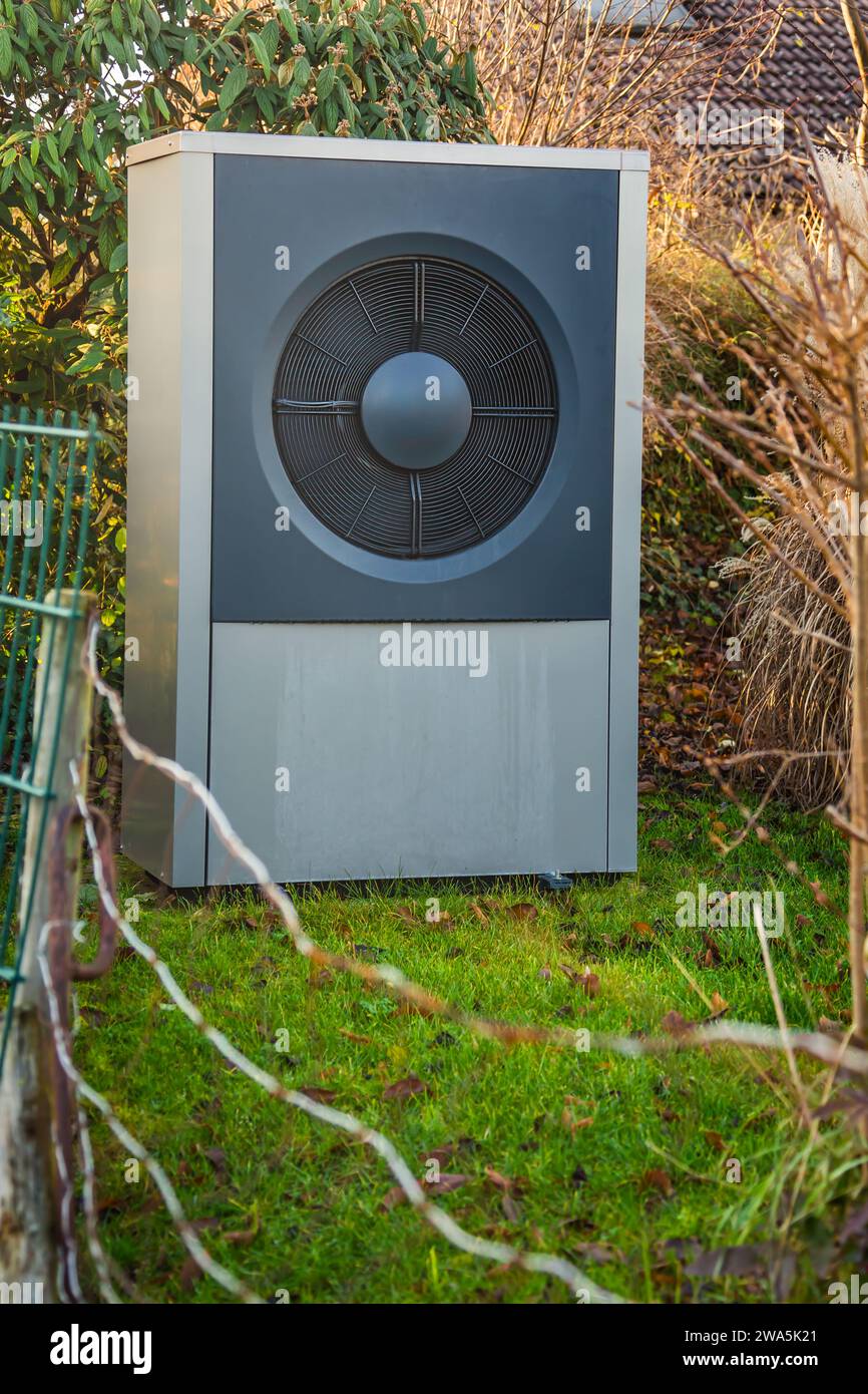 Air source heat pump installed outside in a garden, green renewable