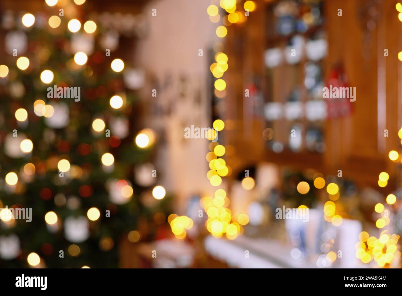 Blurred Section of Living Room Christmas Decoration with Christmas Tree and Lighted Cupboard Stock Photo