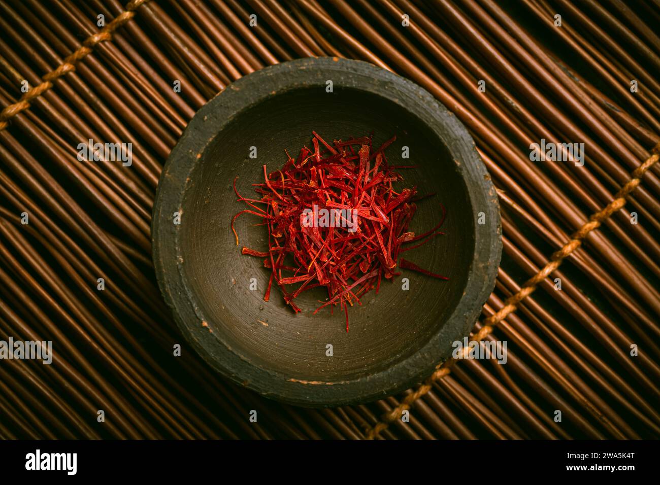 Saffron threads in a small bowl. Spices, cooking ingredients, flavor. Stock Photo