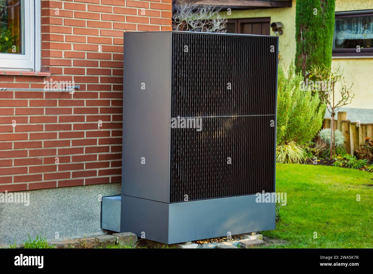 Air source heat pump installed outside in a garden, green renewable