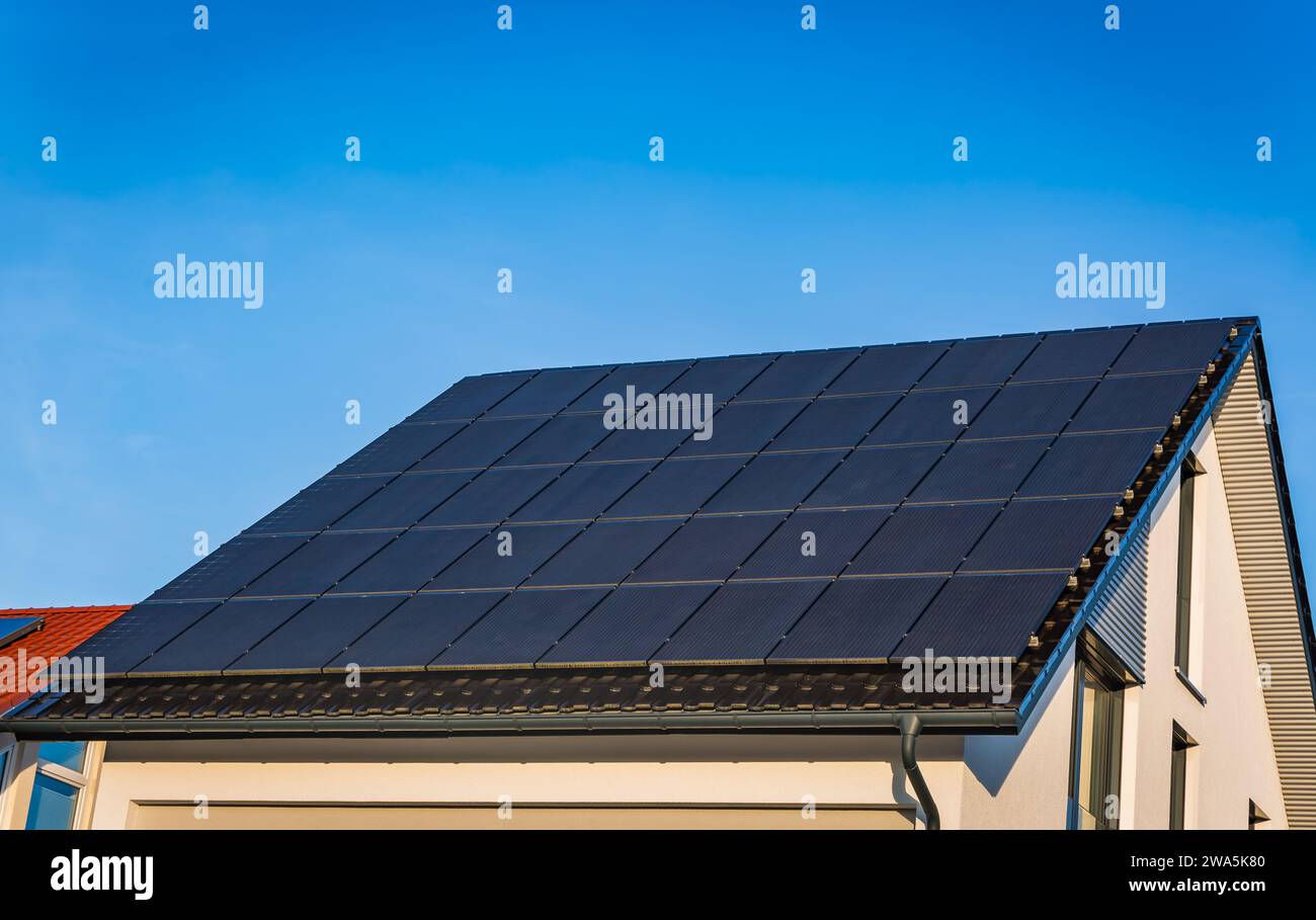 Photovoltaic panels on the roof of family house, solar panels. Environment and technology concepts. Stock Photo