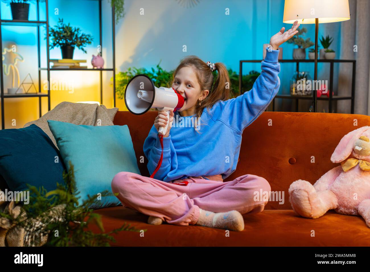 Preteen child girl talking with megaphone, proclaiming news, loudly ...