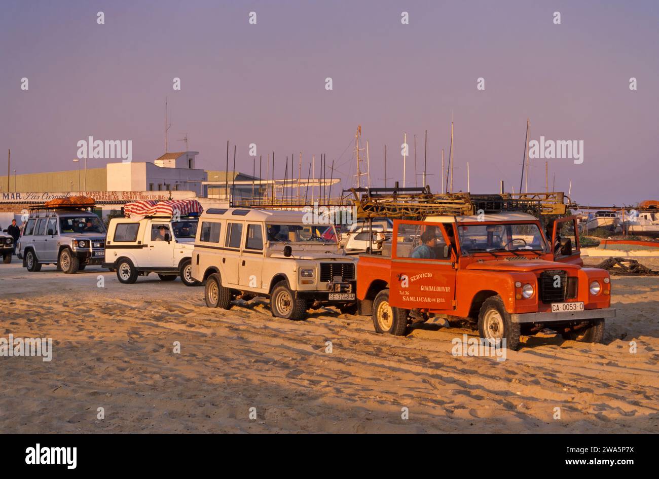 Vehicles in line for ferry to spend weekend at Coto Doñana Natl Park in Sanlucar de Barrameda at Guadalquivir River, Costa de la Luz, Andalusia, Spain Stock Photo