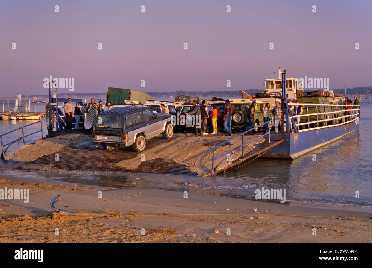 Vehicles loaded at ferry to spend weekend at Coto Doñana Natl Park in Sanlucar de Barrameda at Guadalquivir River, Costa de la Luz, Andalusia, Spain Stock Photo