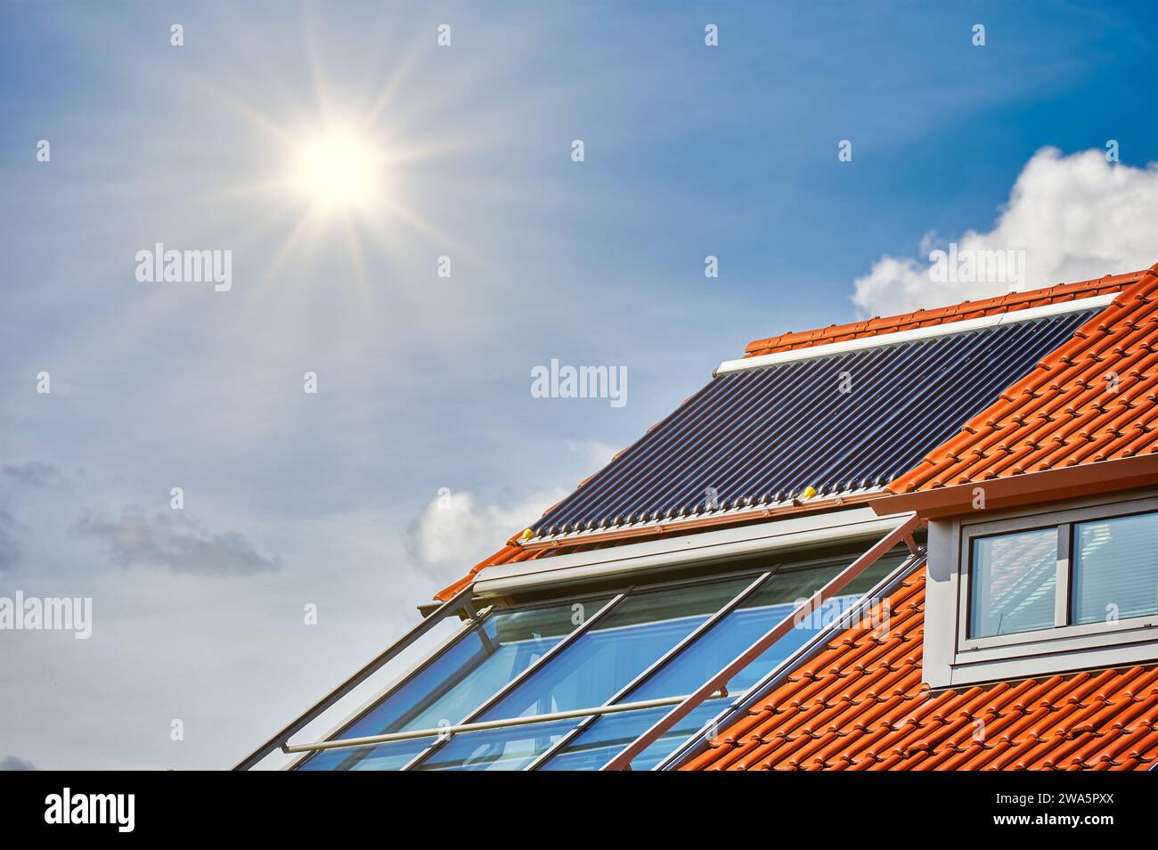 Solar thermal system with tube collectors on a modern house roof in ...