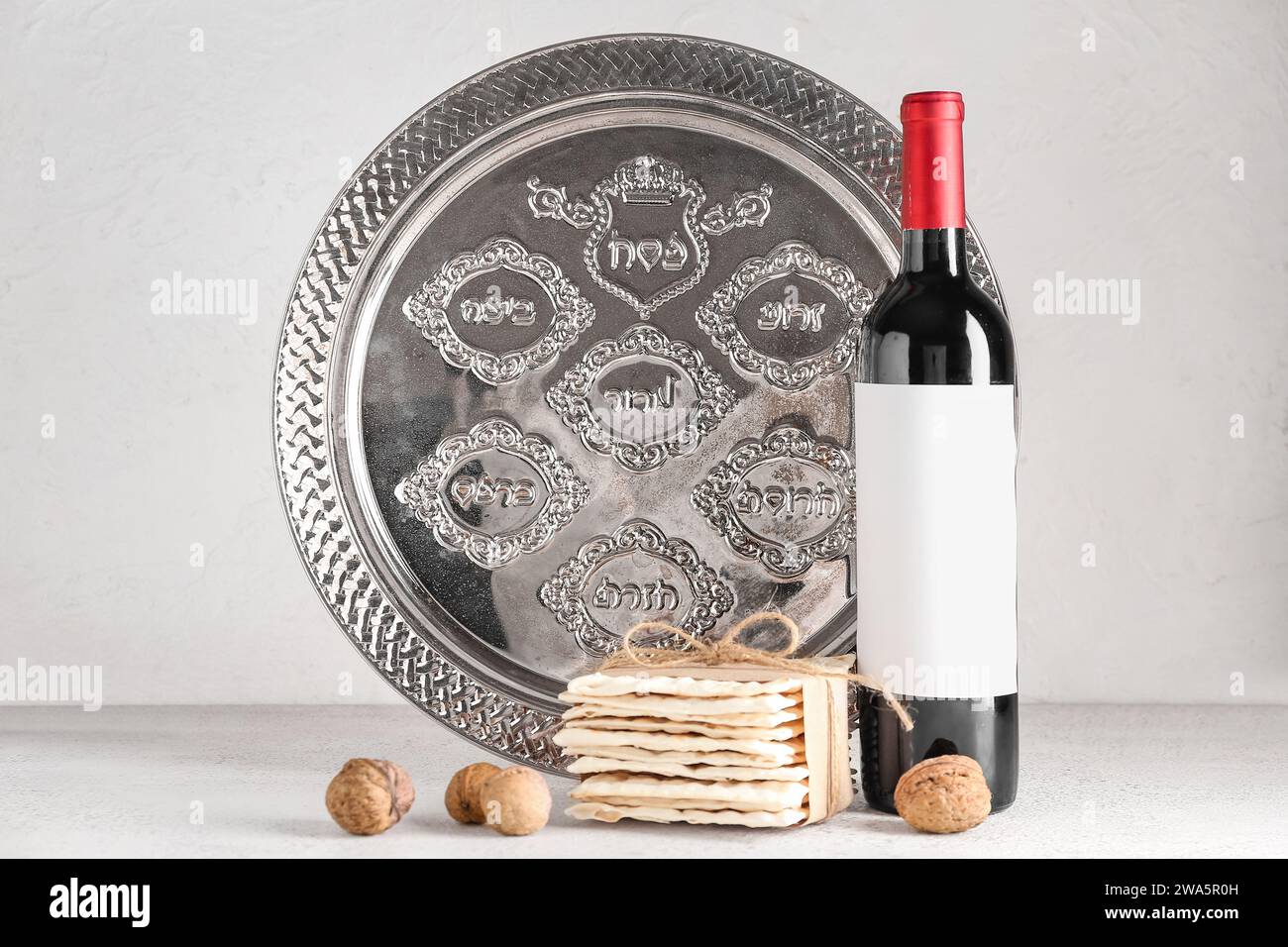 Bottle of wine, Passover Seder plate, flatbread matza and walnuts on ...
