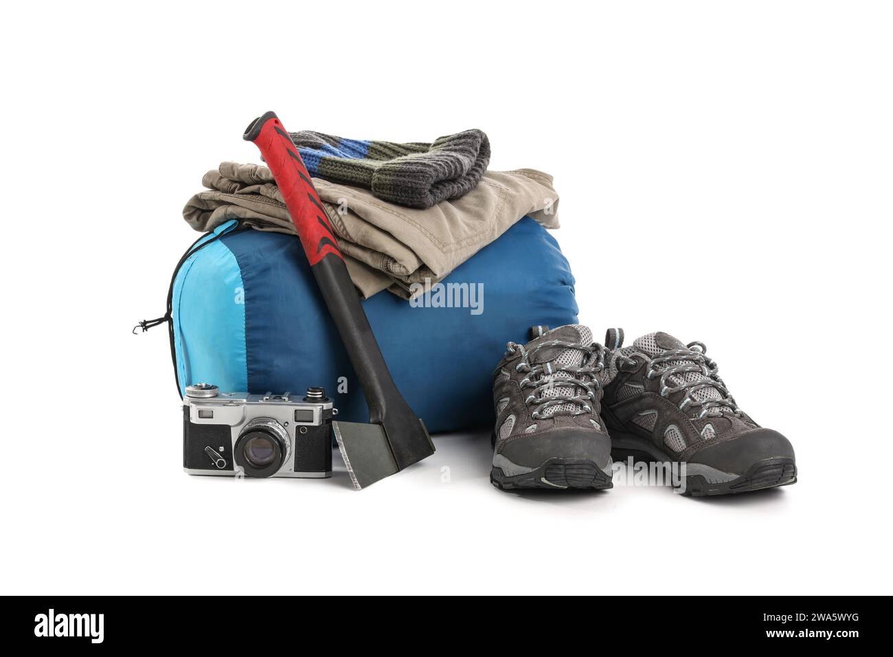 Set of camping equipment with sleeping bag, hatchet and photo camera on white background Stock Photo