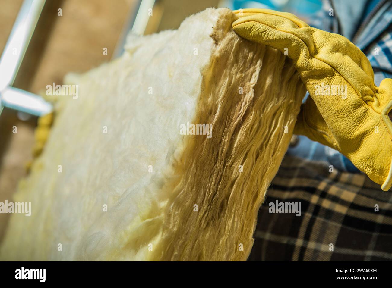 Mineral Wool Insulator Installing by Professional Construction Worker