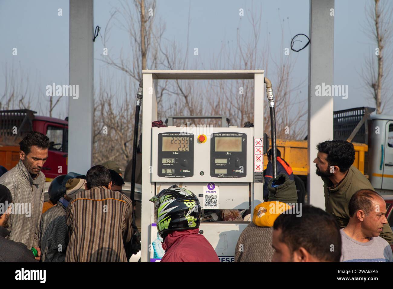 Srinagar, India. 02nd Jan, 2024. People wait in a queue to refill fuel cans at a fuel station. Petrol stations in various Indian states are witnessing long queues as a result of continuous protests by truck and bus drivers across the country against the new panel law on hit-and-run cases. The newly established Bharatiya Nyaya Sanhita law, which repealed the British-era Indian Penal Code, imposes a 10-year prison sentence and a 184.76 US dollars fine for escaping an accident scene and failing to report the incident. (Photo by Faisal Bashir/SOPA Images/Sipa USA) Credit: Sipa USA/Alamy Live News Stock Photo