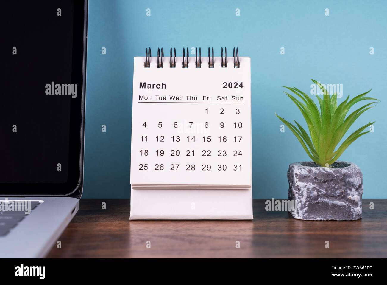 March 2024 desk calendar and potted plant Stock Photo - Alamy
