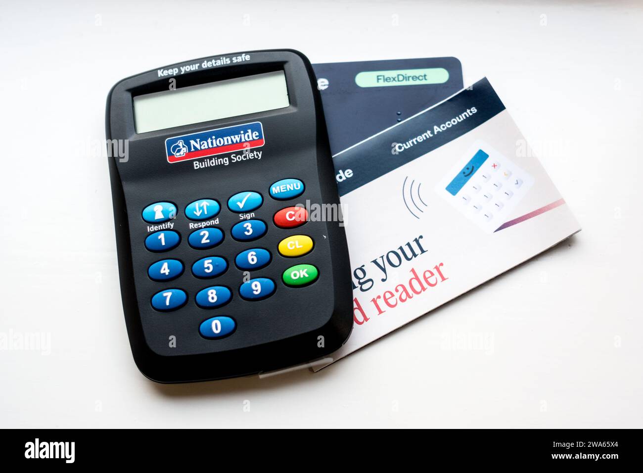 Bank card reader machine for secure online banking with instructions booklet Stock Photo