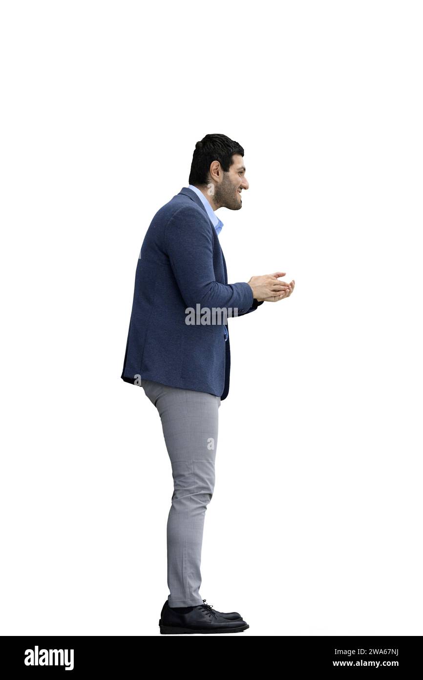 A man in a jacket on a White background rubs his hands. In profile Stock Photo