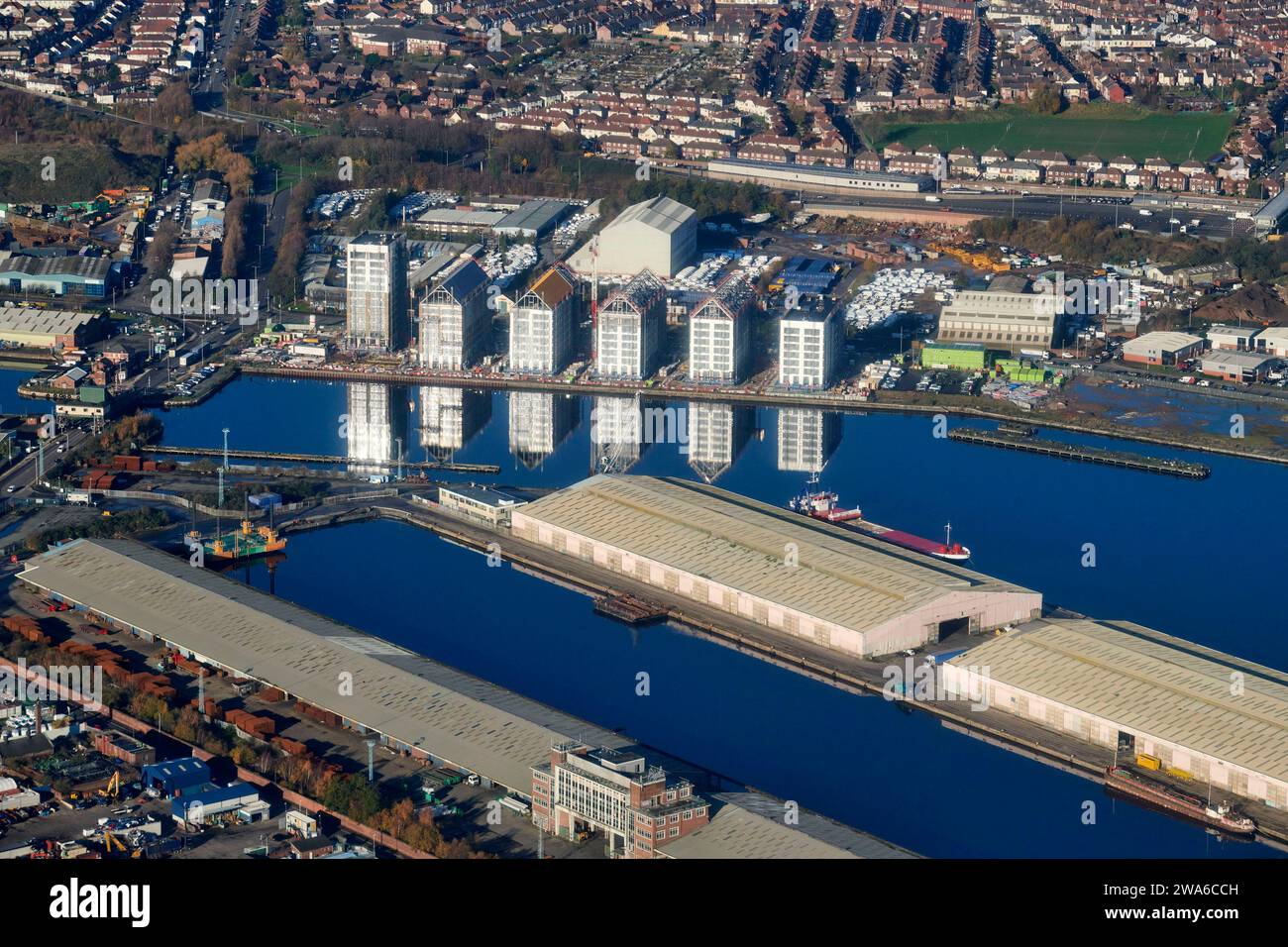 New buildings reflected in Birkenhead dock shot from the air, River