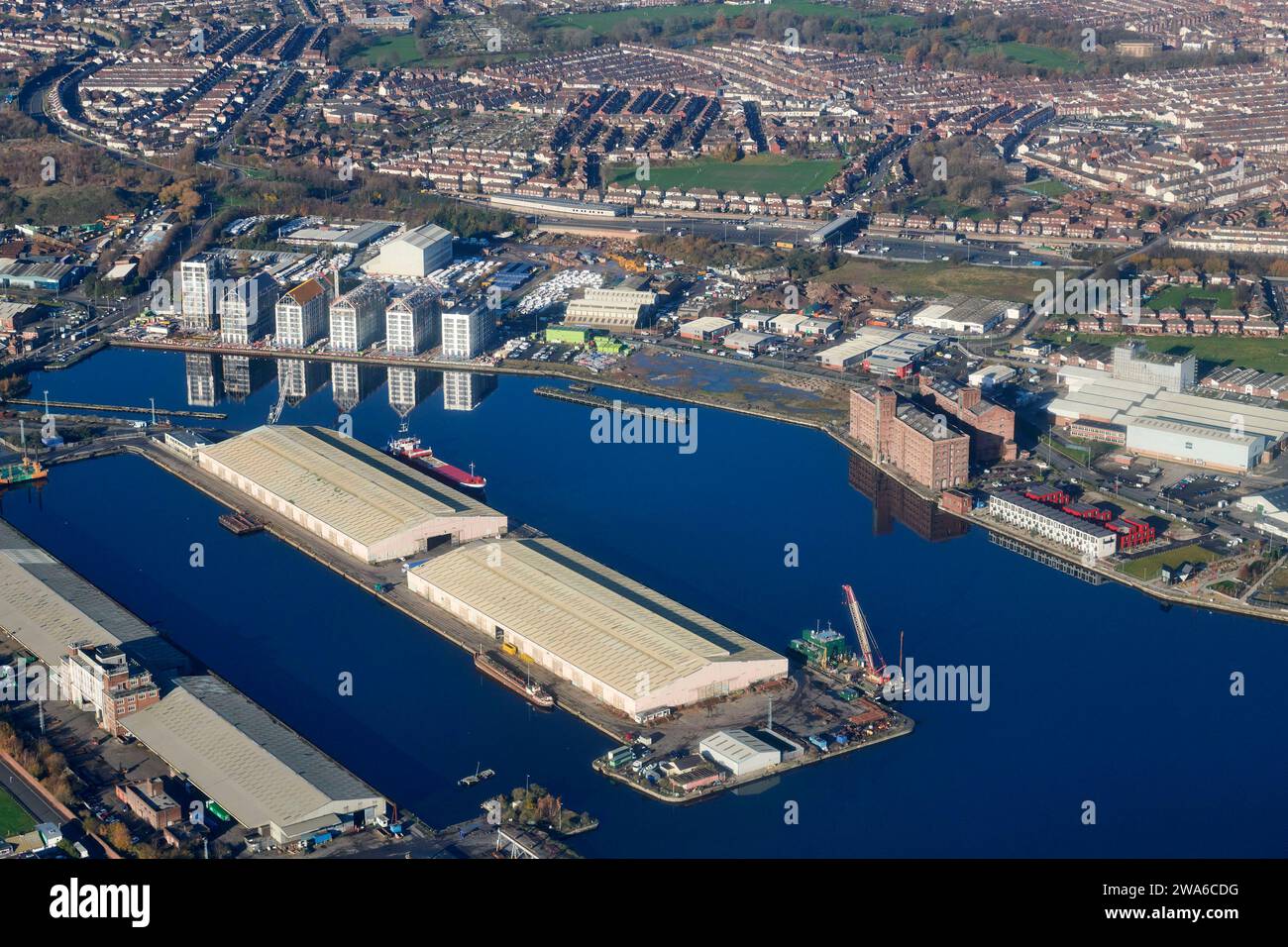 New buildings reflected in Birkenhead dock shot from the air, River Mersey, Merseyside, north