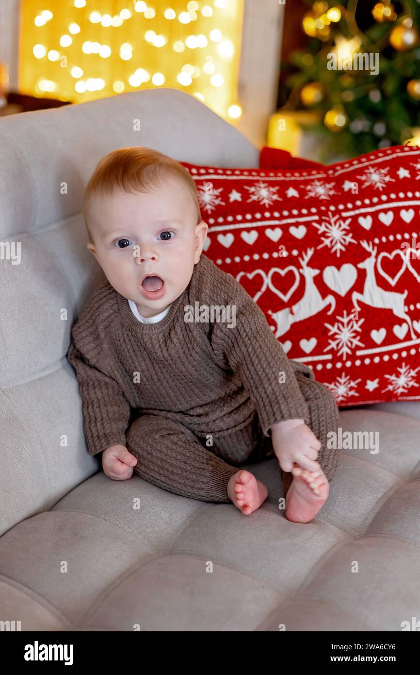 Cute newborn child, baby boy, with mom and dad on Christmas at home, enjoying first christmas holiday Stock Photo