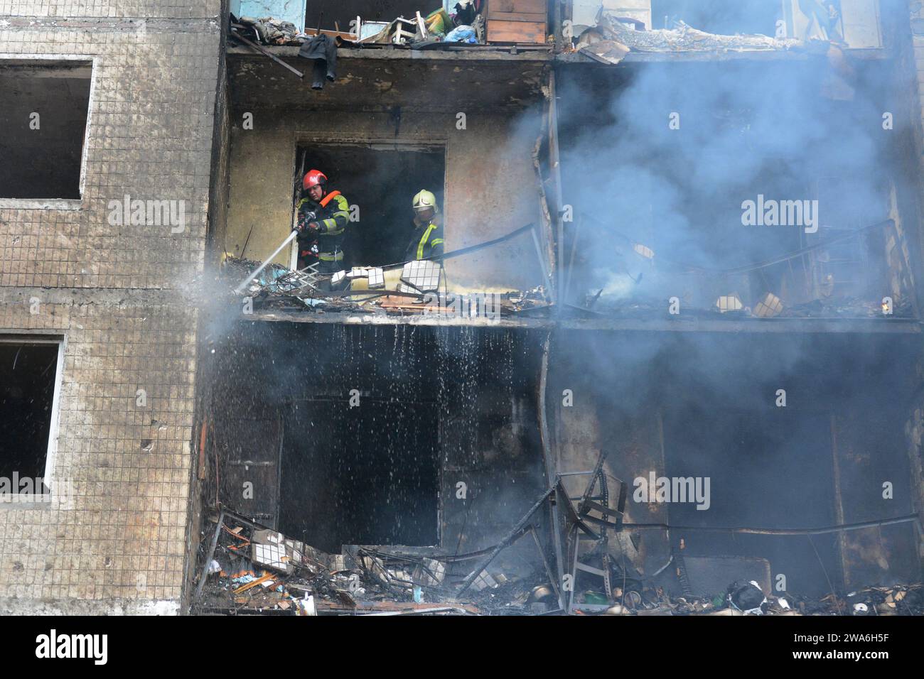 Firefighters attempt to extinguish a fire in a multi-storey building ...