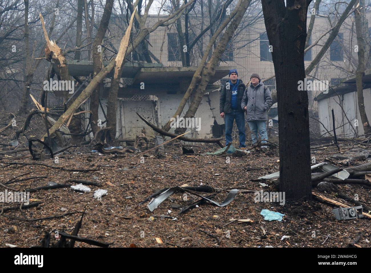 Kyiv Ukraine 02nd Jan 2024 Two Men Are Seen Against The Background   Kyiv Ukraine 02nd Jan 2024 Two Men Are Seen Against The Background Of Debris And Destroyed Trees Next To A High Rise Building Destroyed By A Rocket Attack In The Center Of Kyiv Today Morning Russian Forces Launched A Massive Missile Strike On Kiev Debris Fell And Buildings Caught Fire In Several Districts Of The City The Consequences Were Particularly Severe In The Solomianskyi District Where A Multi Story Building Caught Fire Photo By Aleksandr Gusevsopa Imagessipa Usa Credit Sipa Usaalamy Live News 2WA6HCG 