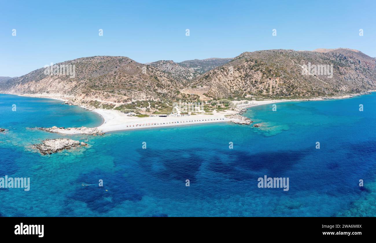 Crete island Greece. Aerial drone panoramic view of Paleochora town, transparent crystal clear sea water, blue sky, underwater rocky formation. Stock Photo